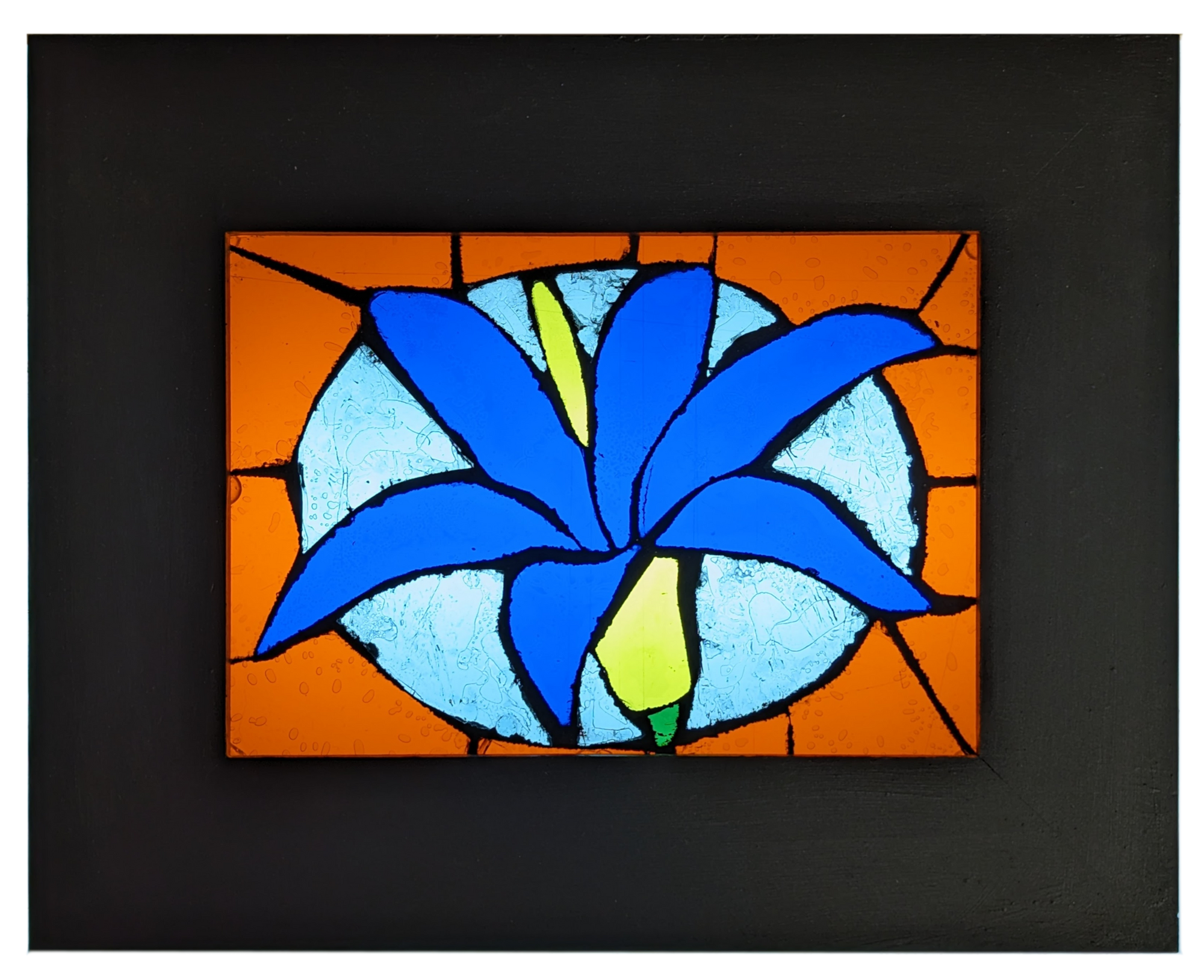 A glass mosaic of a blue flower.