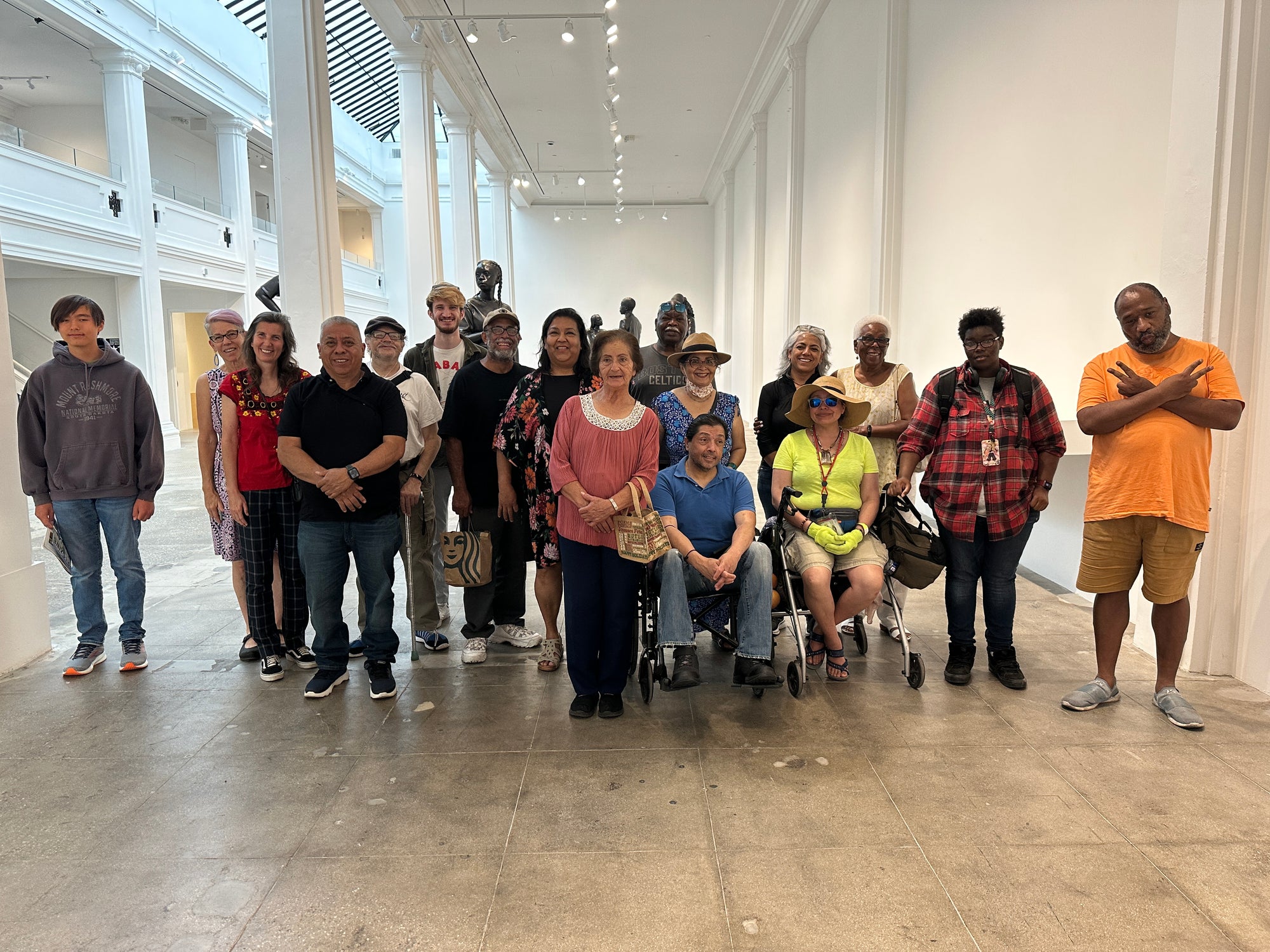 A group of artists posing at a museum hall.