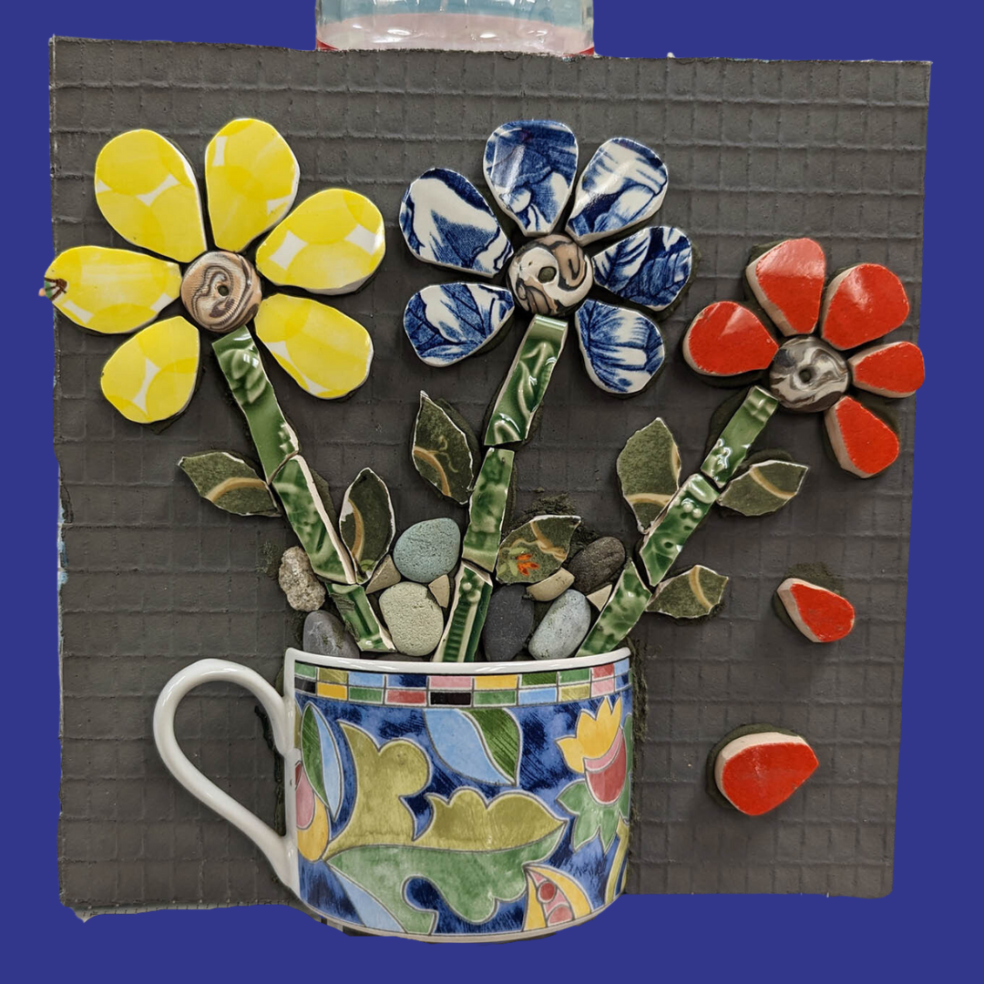 A mosaic of a mug of yellow, blue, and red flowers.