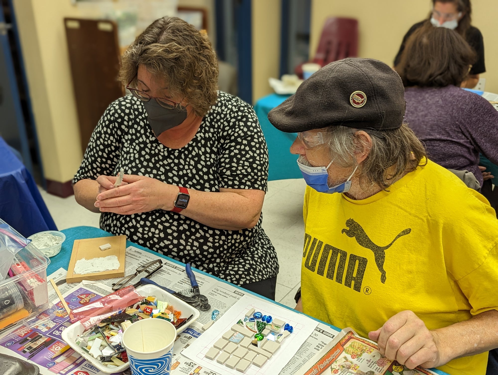 Artists working on mosaics at a Piece by Piece workshop.