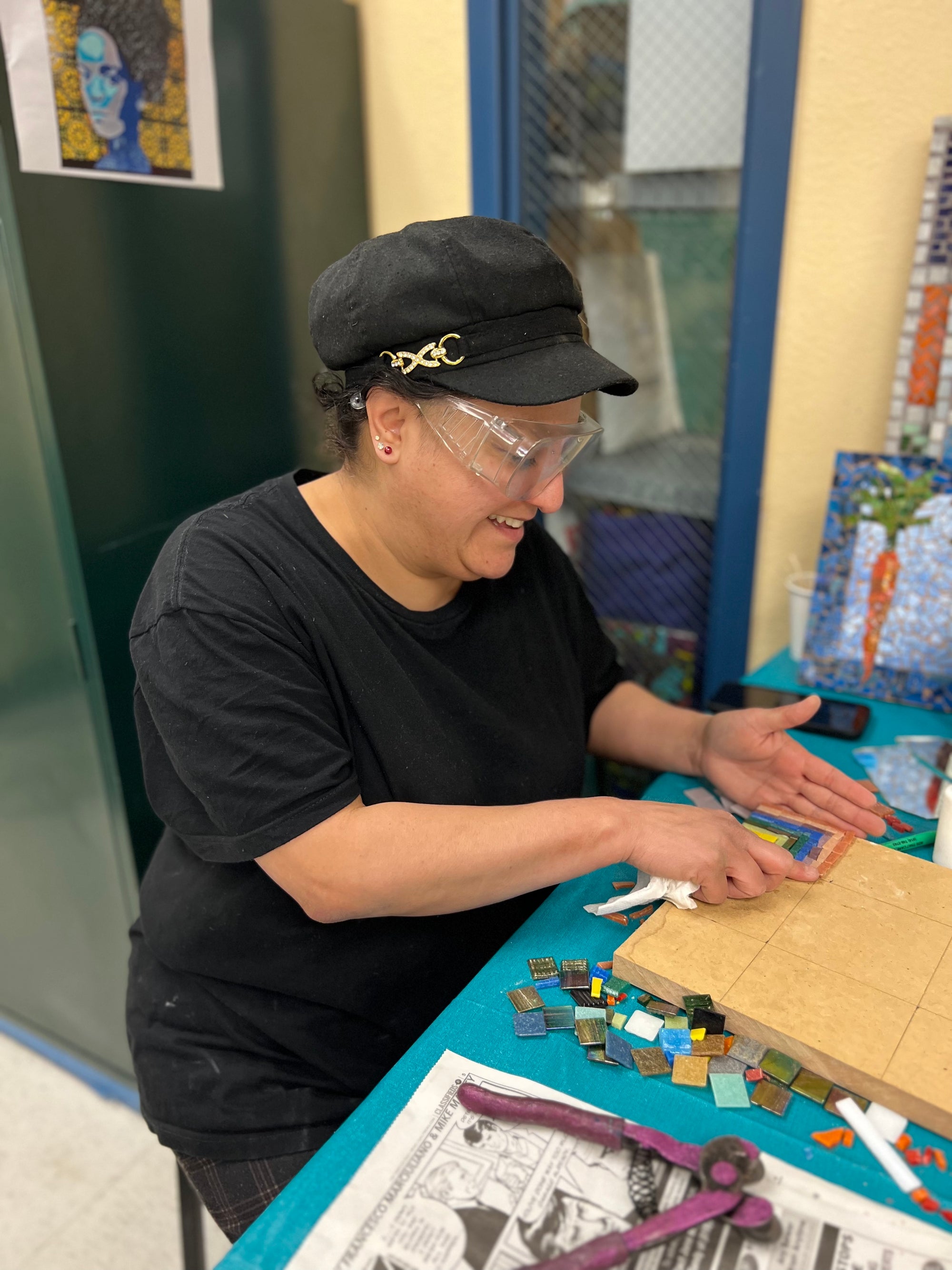Artist working on mosaic at a Piece by Piece workshop.