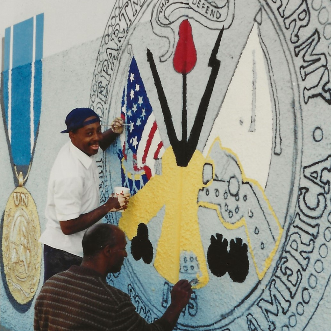Artist working on a large mosaic to honor veterans.