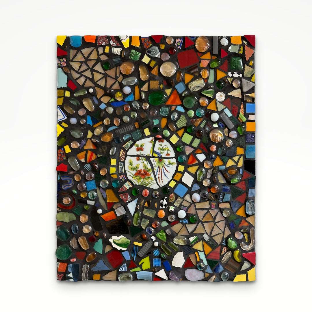 Colorful absract mosaic with lots of small rectangles and circles and a floral ceramic detail in the center.