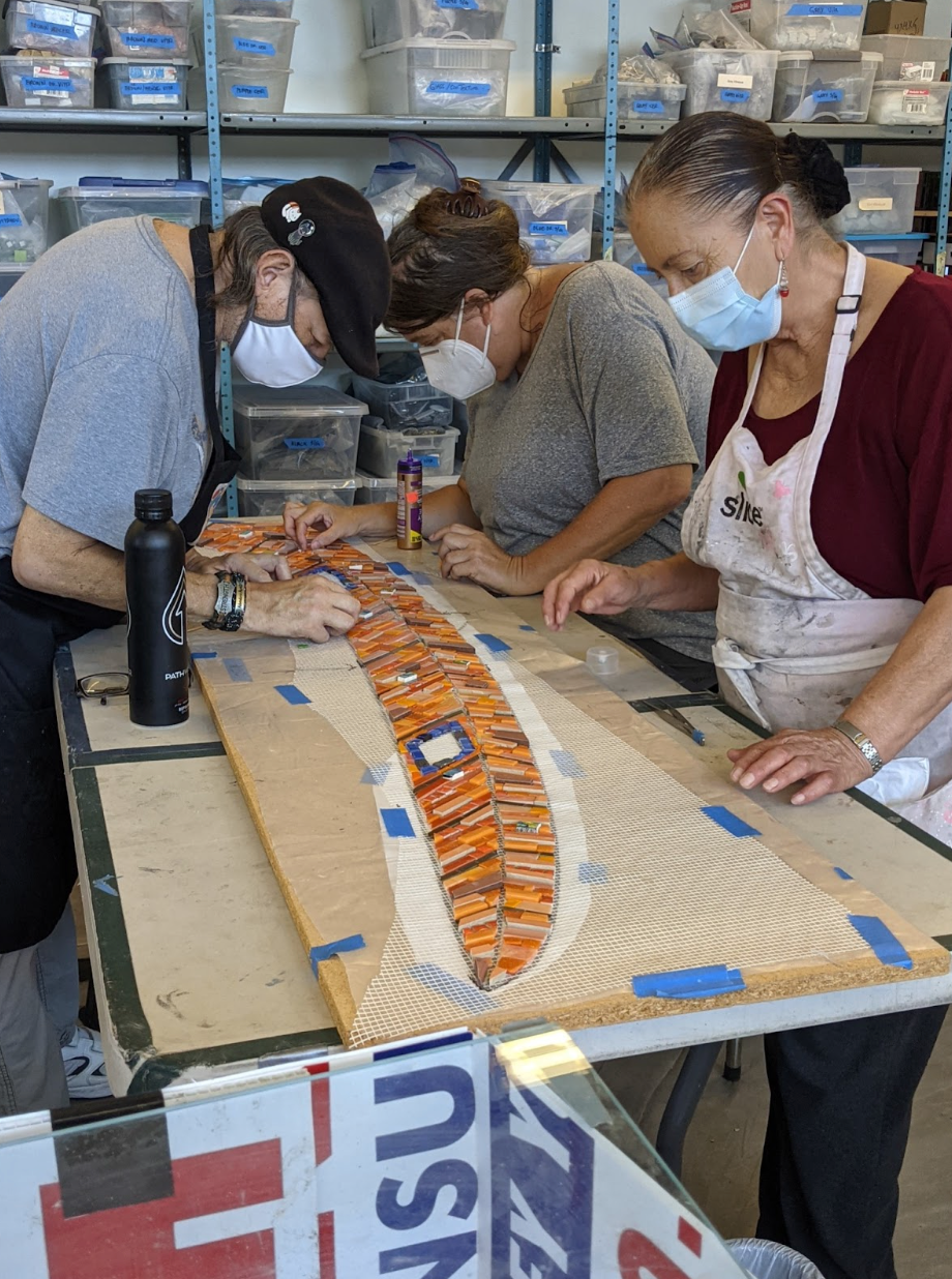 Piece by Piece artists working on a large-scale mosaic
