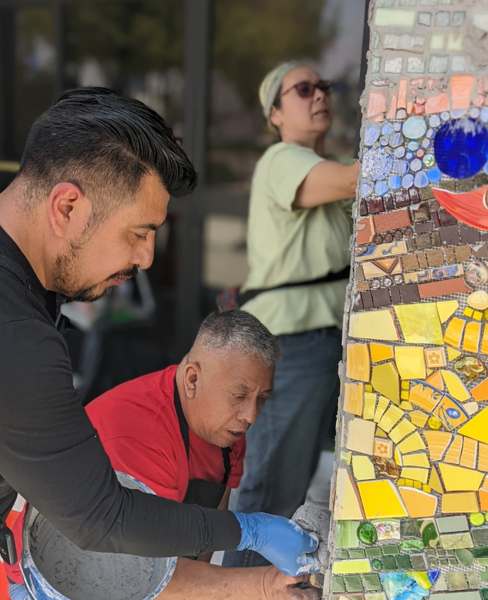 Piece by Piece artists installing the Brilliance of Community mosaic