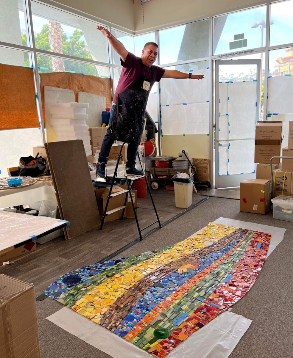 Piece by Piece instructor Jose working on the Brilliance of Community Mosaic in the studio