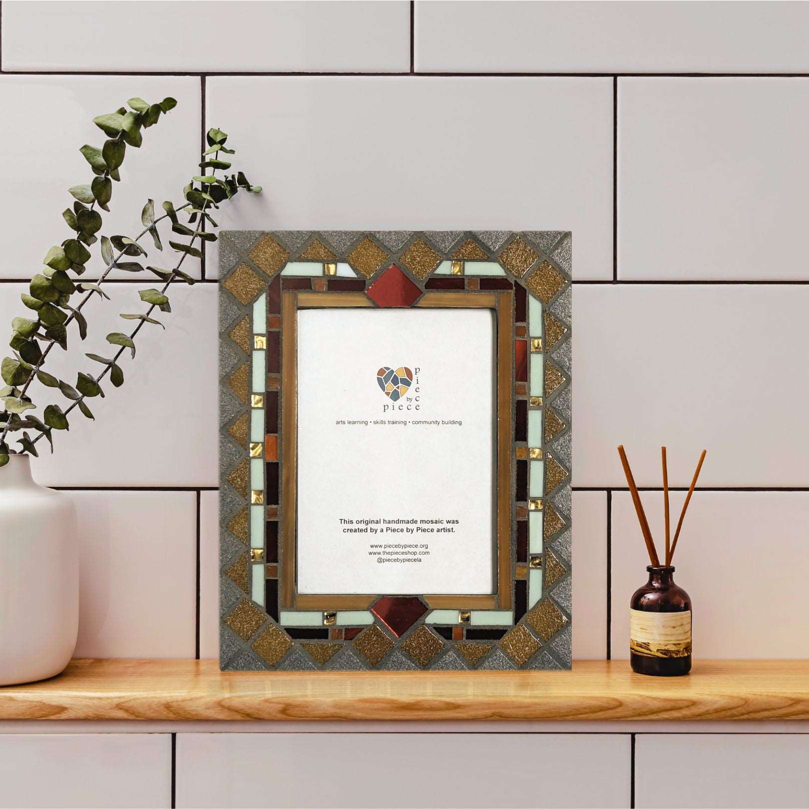 Jewel-toned mosaic frame with gold details.