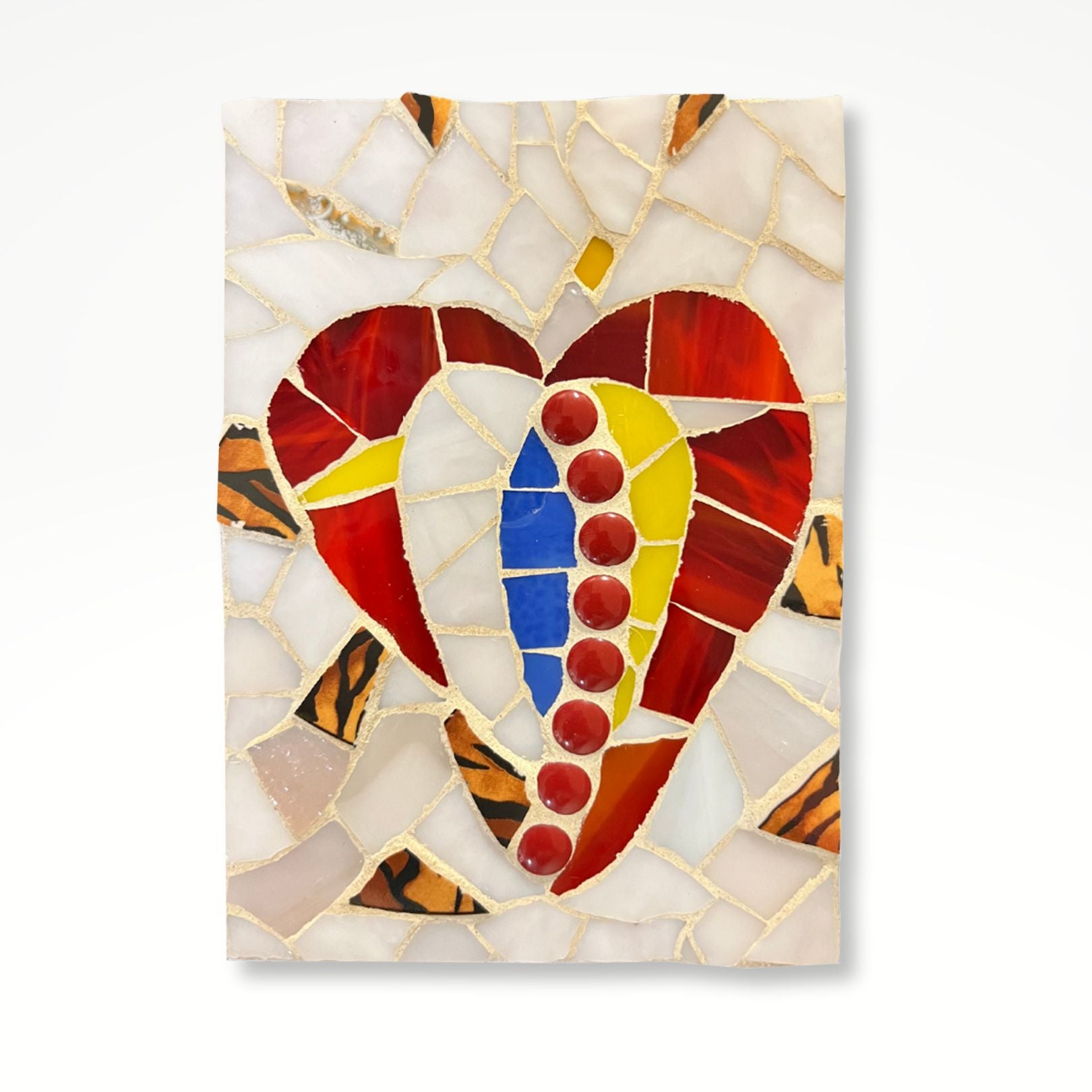 Abstract mosaic heart made up of red, blue, and yellow pieces with a muted pearly background and golden accents. 